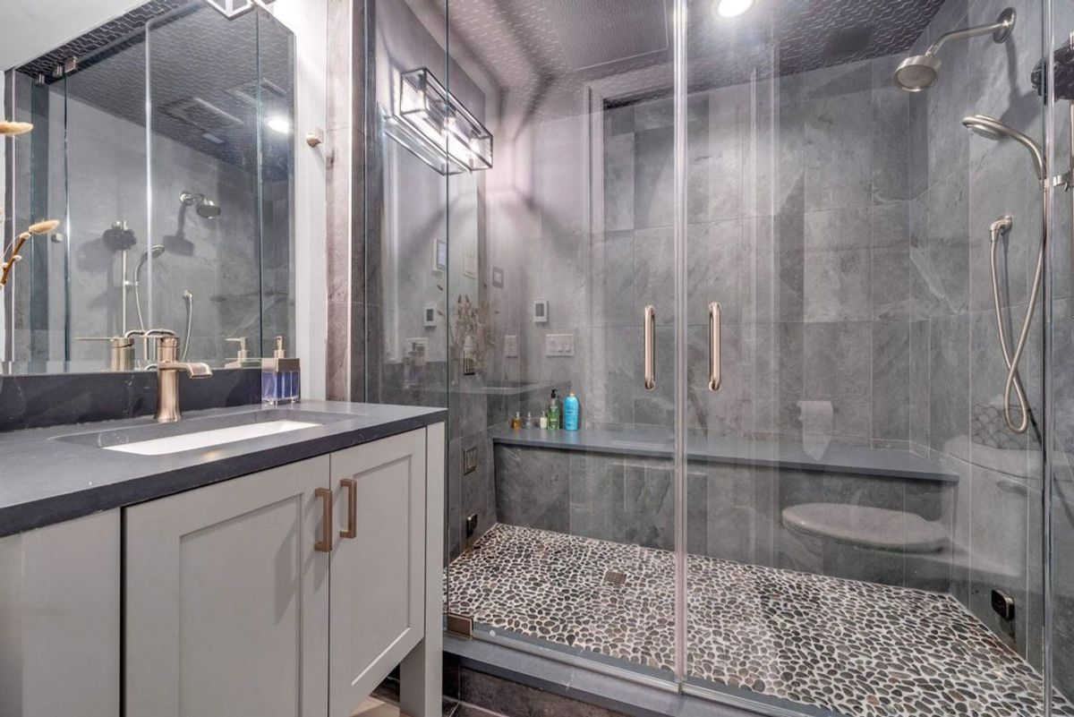 Bathroom features a large glass-enclosed shower