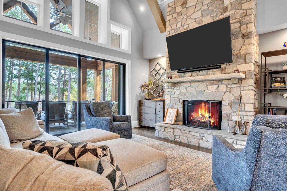 Living room features a stone fireplace.