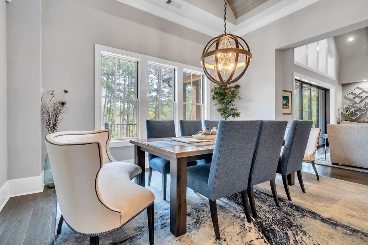 Dining room pairs elegant blue chairs.