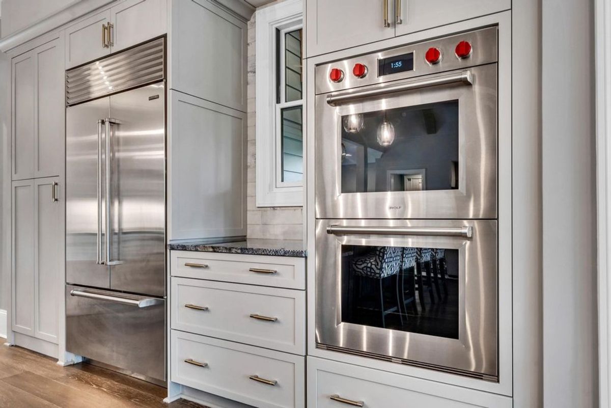 Double oven and stainless steel refrigerator anchor.