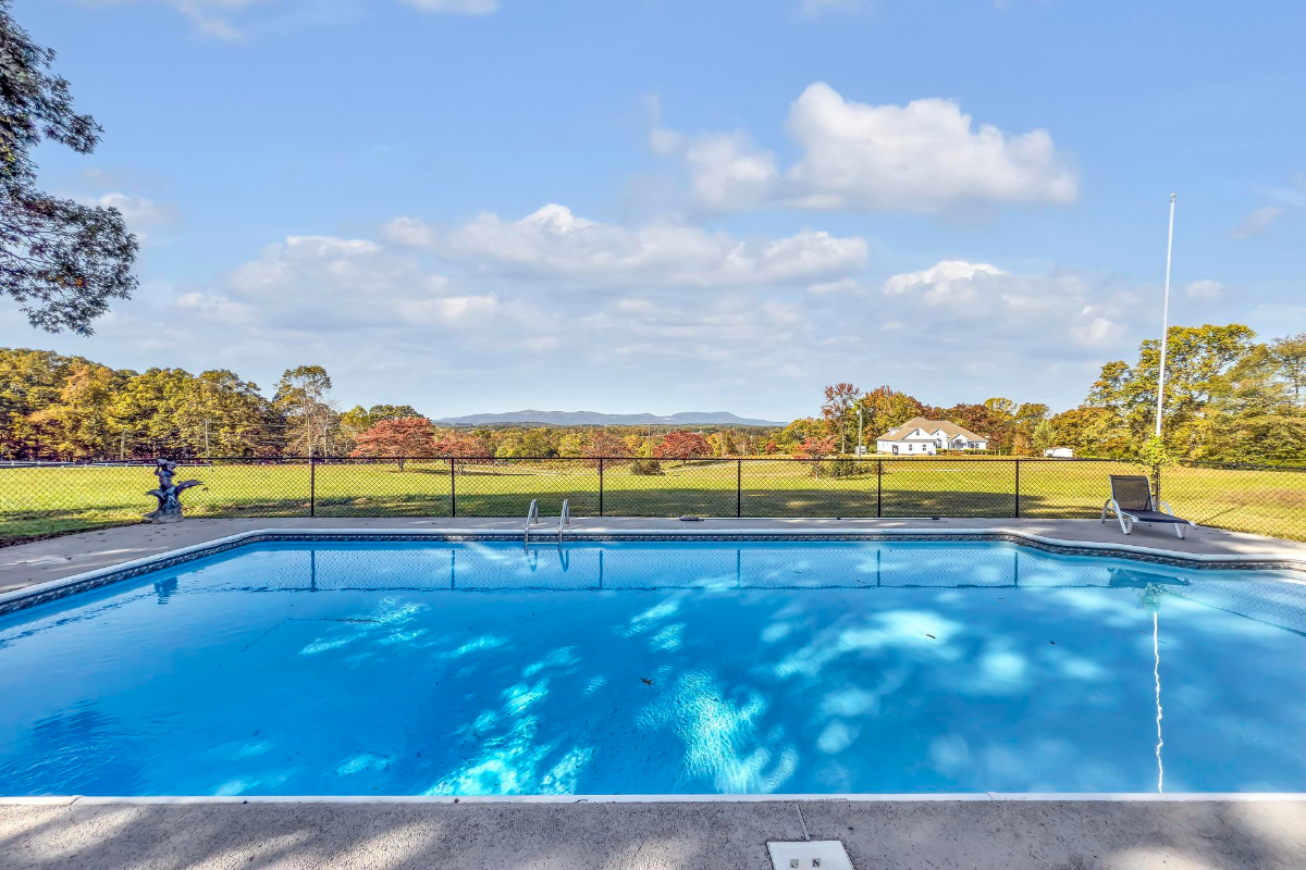 A sparkling pool framed by panoramic countryside views provides an idyllic space for relaxation and outdoor enjoyment.