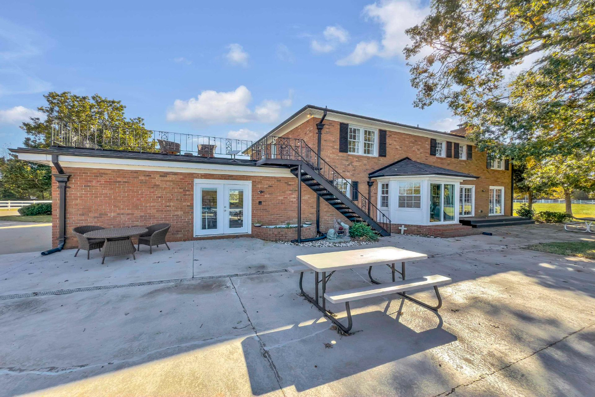 Patio offers ample space for outdoor seating, highlighted by access to the upper-level terrace.