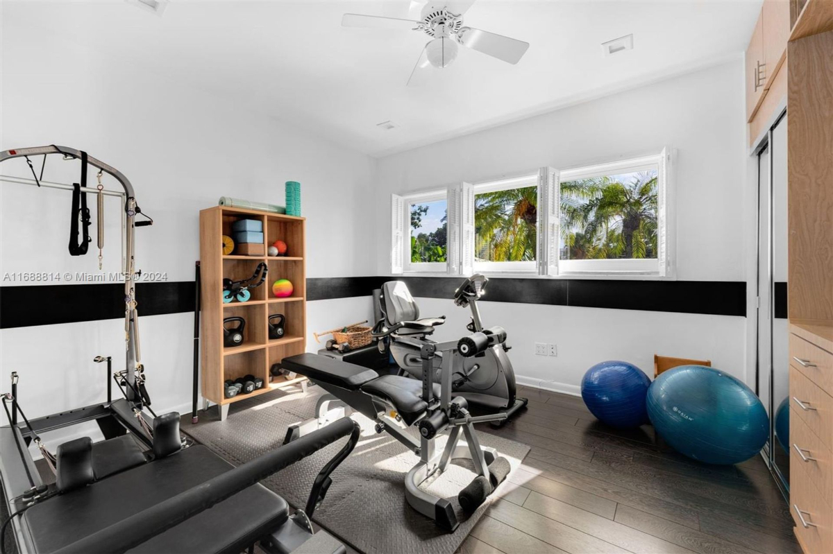 Home gym with natural light and a range of fitness equipment.