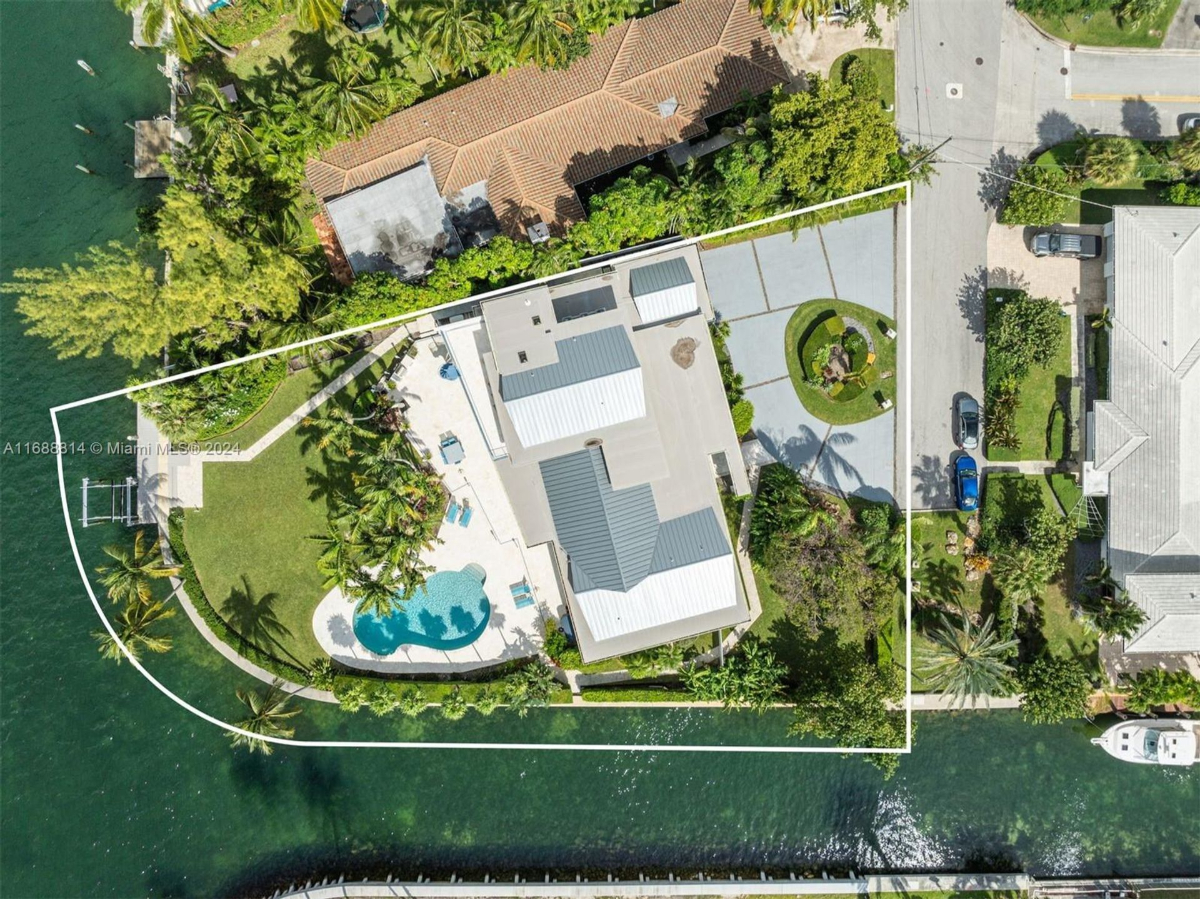 Aerial view showcasing the expansive waterfront property and its lush surroundings.