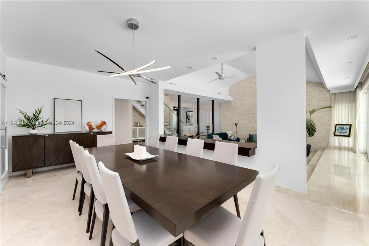 Elegant dining area with modern chandelier and seating for ten.