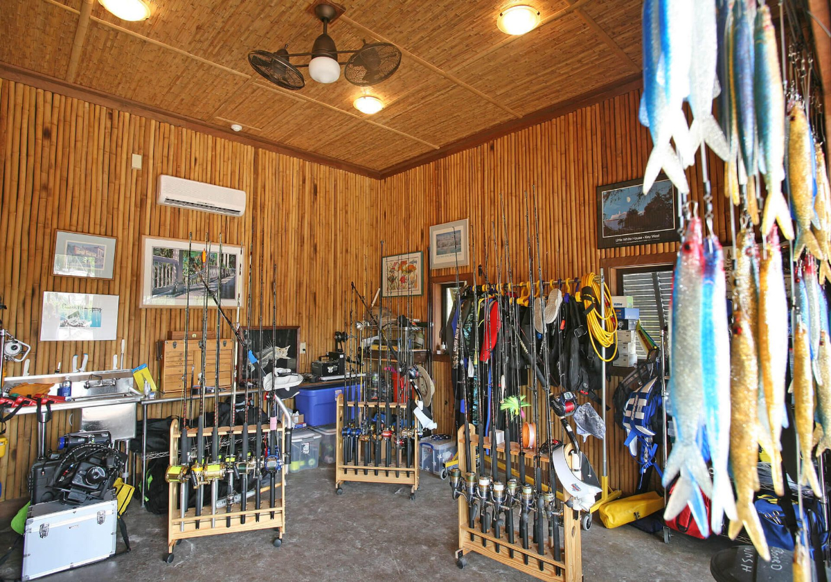 The well-organized fishing tackle room showcases bamboo walls and ample storage for rods, reels, and gear.