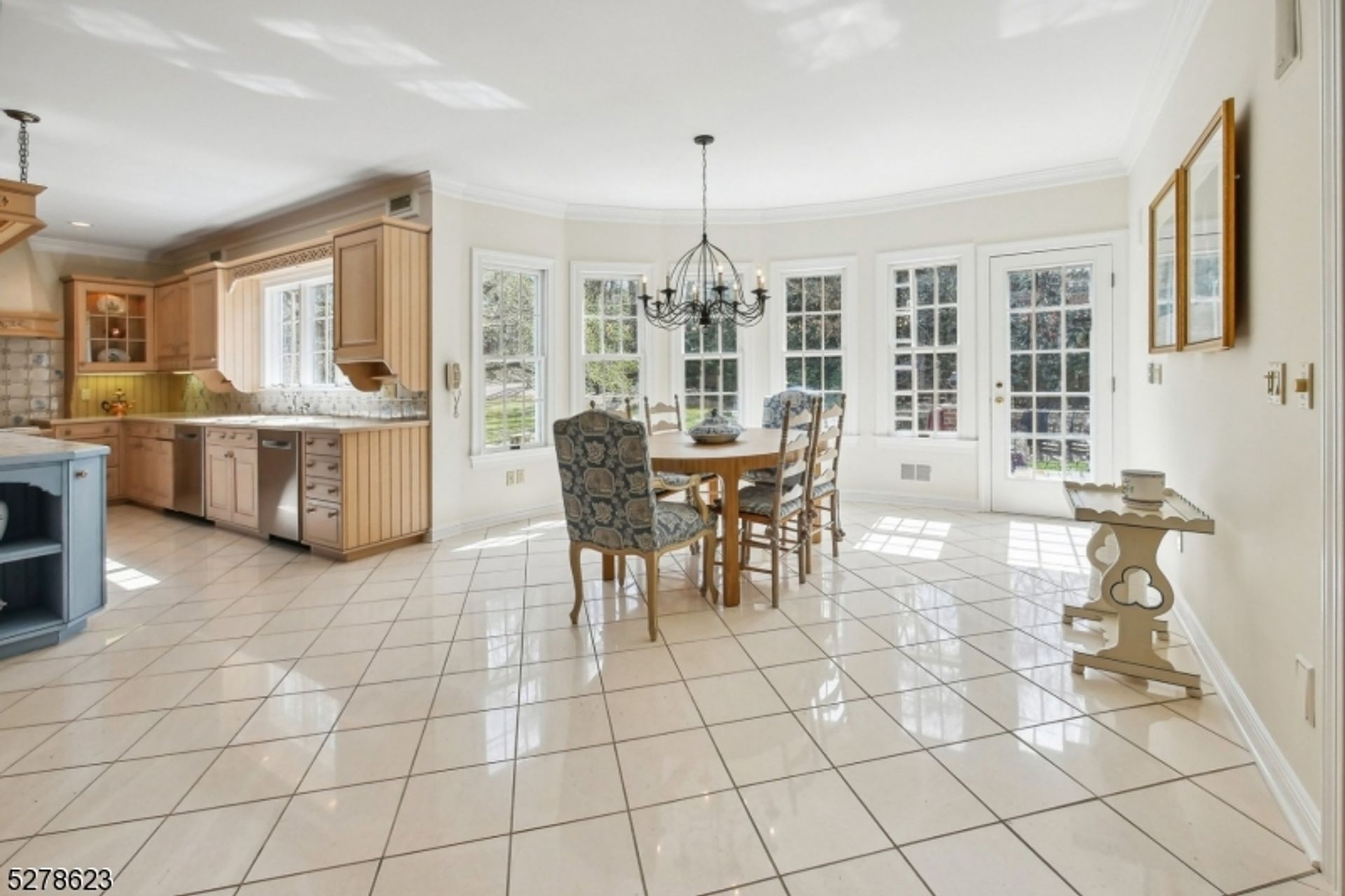 Sunlit breakfast nook with panoramic windows and garden views, perfect for morning gatherings.