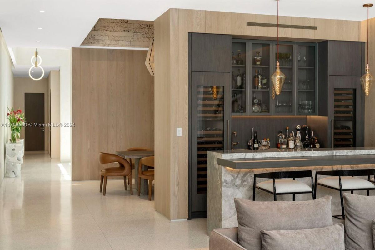 Custom bar area with built-in wine storage, sleek cabinetry, and modern lighting accents.