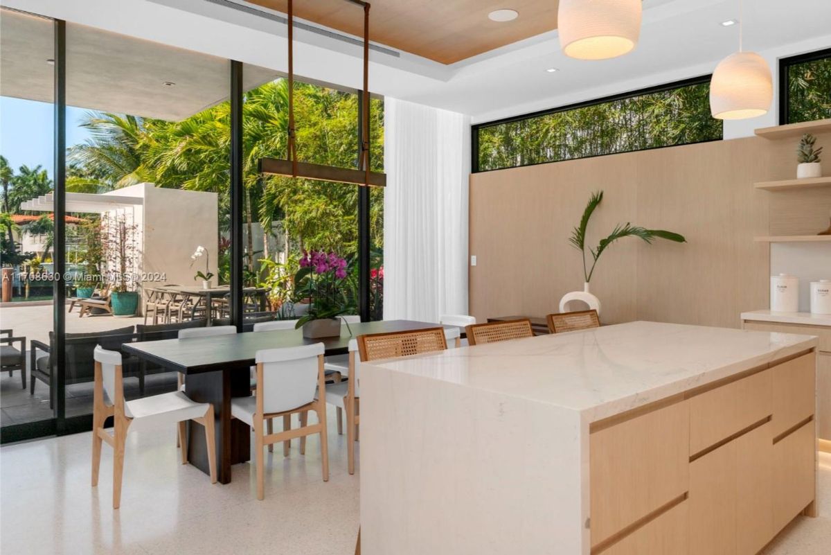 Dining area blending contemporary design with natural light and outdoor access.