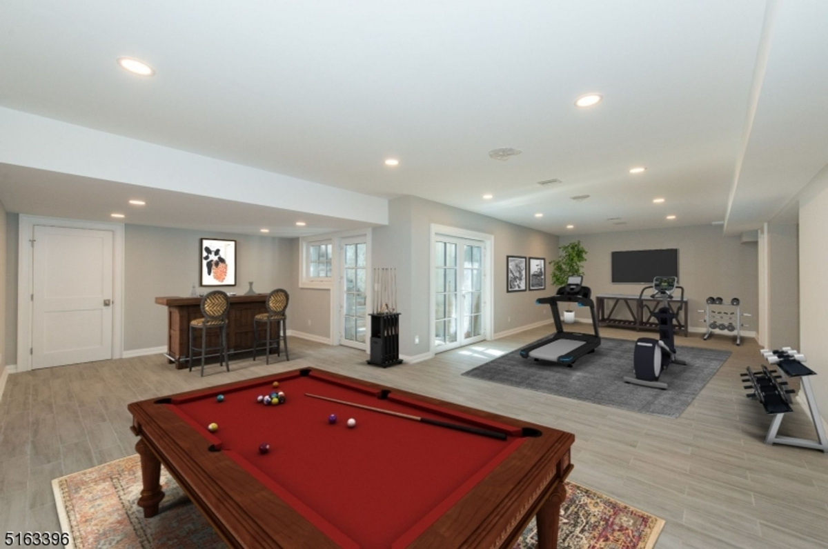 Spacious recreation room with fitness and entertainment zones.