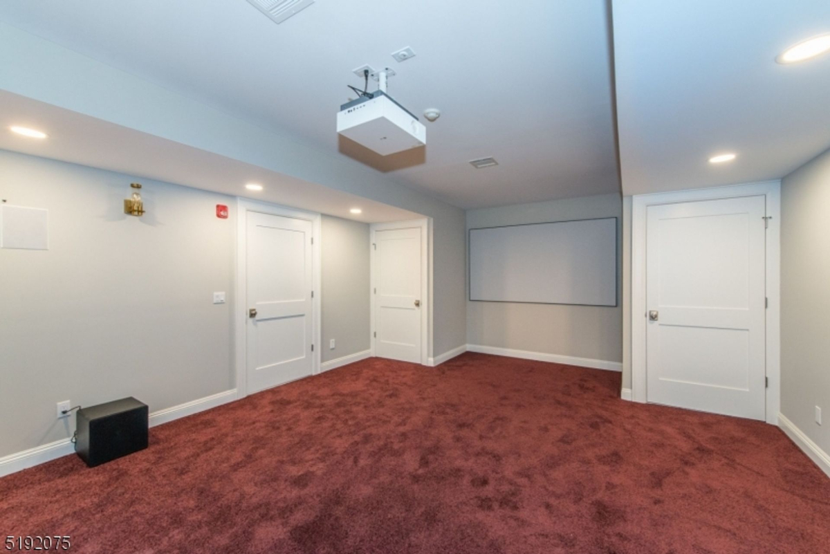 Dedicated home theater room with cozy carpeting.