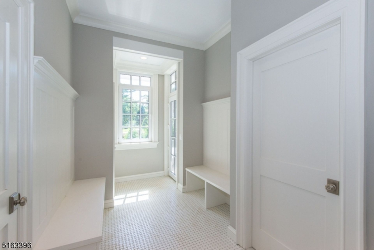 Bright and functional mudroom features built-in seating and storage with direct outdoor access.