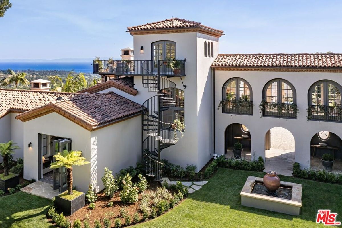 Spiral staircase leads to a private rooftop terrace.