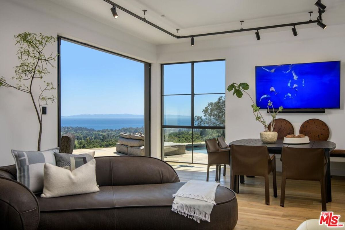 Modern elegance meets panoramic ocean views in this serene living and dining space.