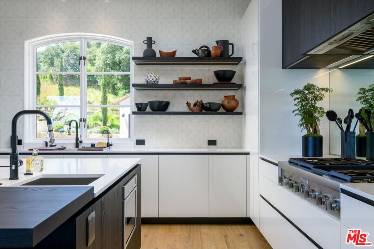 Bright kitchen corner features open shelving.