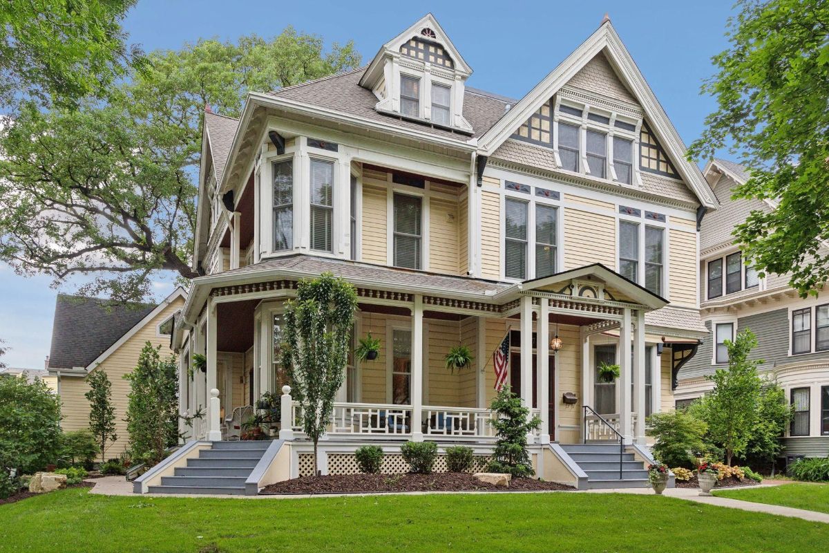 A large Victorian house with a wraparound porch.