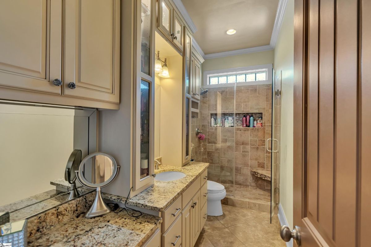 A bright and elegant bathroom showcases granite countertops.