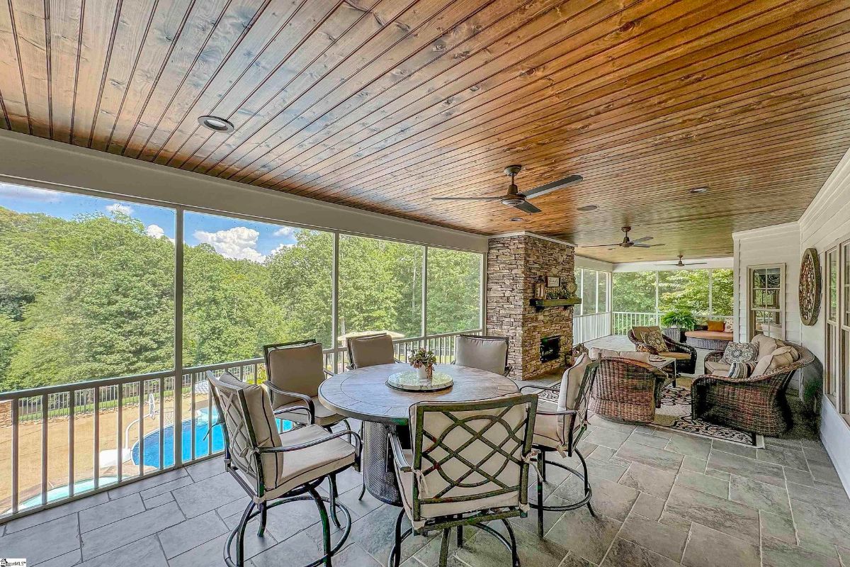 Screened-in porch with a wood-paneled ceiling.