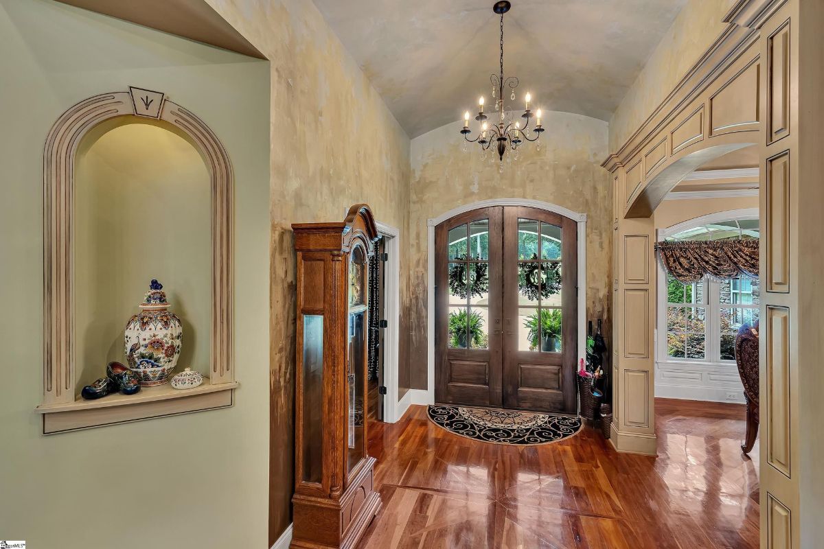 Grand foyer showcases rich hardwood flooring.