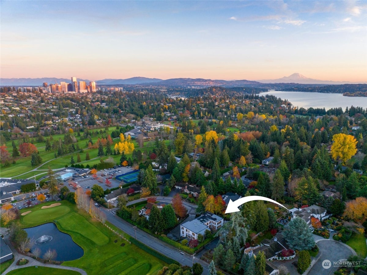 An aerial shot of a residential area, with a golf course and a body of water visible in the foreground.