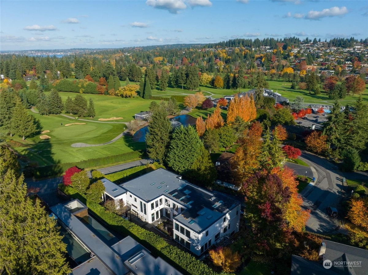 Large house situated near a golf course.