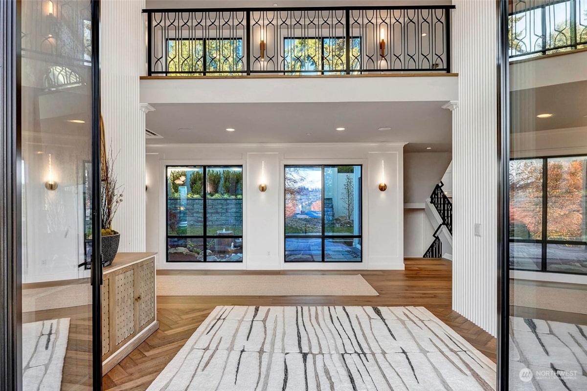 Spacious entryway or foyer with high ceilings and a second-story balcony visible above.