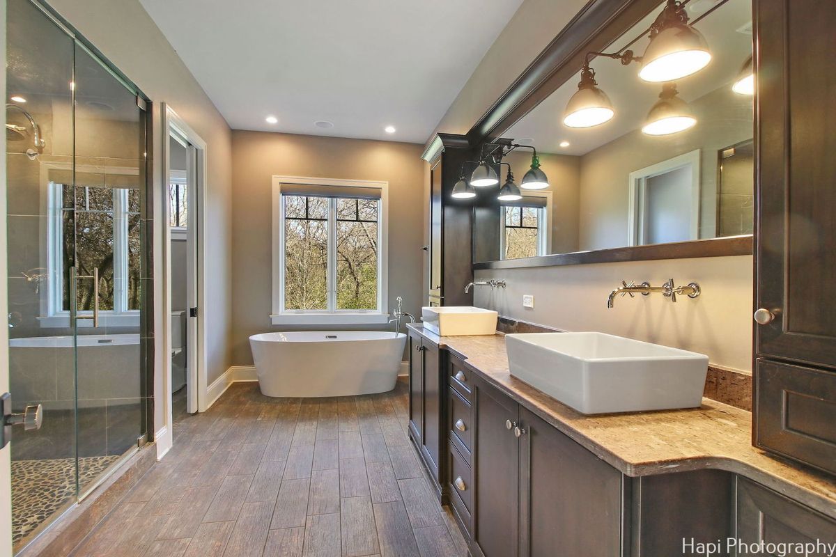 Bathroom with a freestanding bathtub, double vanities, and a walk-in shower.