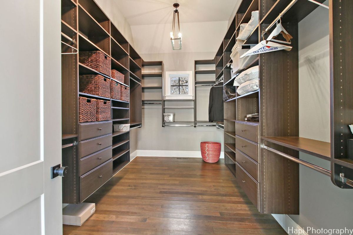 Large walk-in closet with ample shelving, drawers, and hanging space.