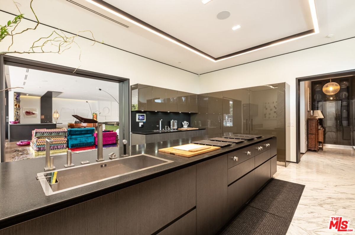 Sleek and modern kitchen with dark cabinetry and high-end appliances.