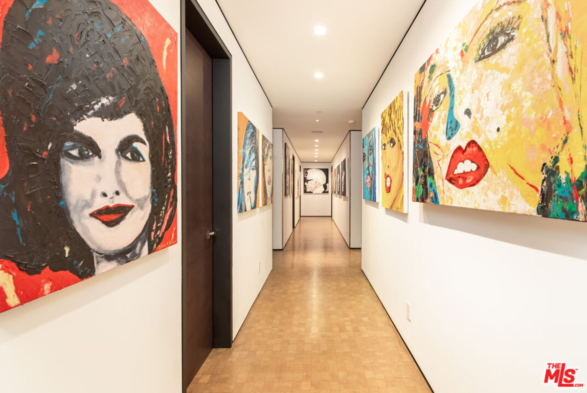 Art gallery-style hallway with a collection of portraits.