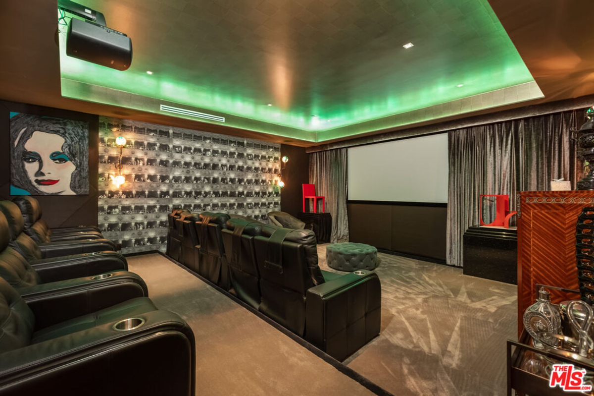 Home theater with comfortable seating and a large screen.