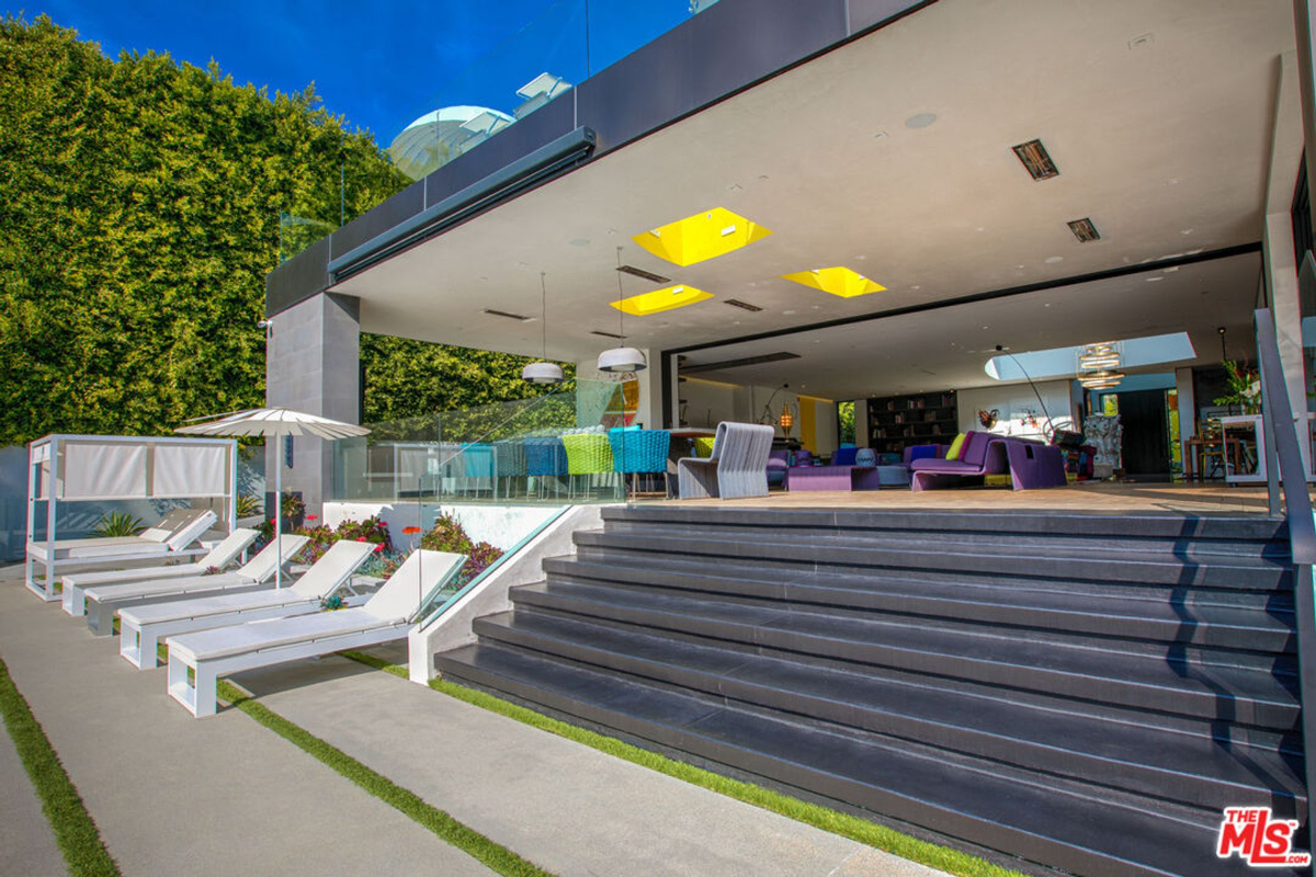 Modern home with a poolside patio and steps leading up to the main house.