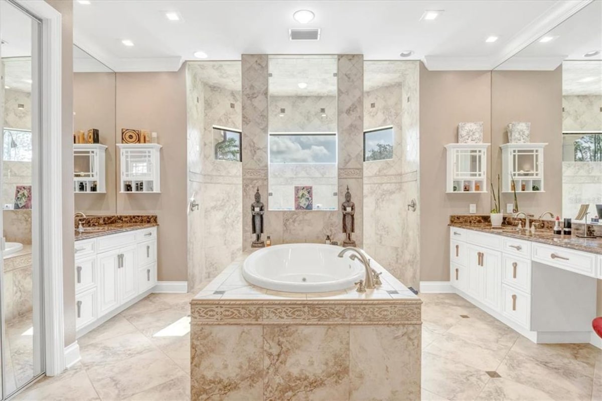 Bathroom with a freestanding bathtub as the central feature. 