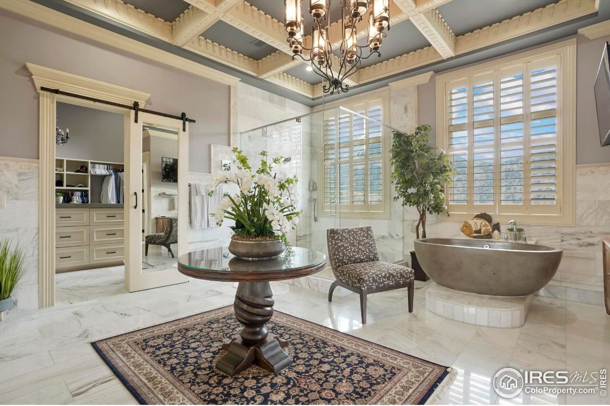 Luxurious master bathroom features a freestanding tub, walk-in shower, and a large closet.