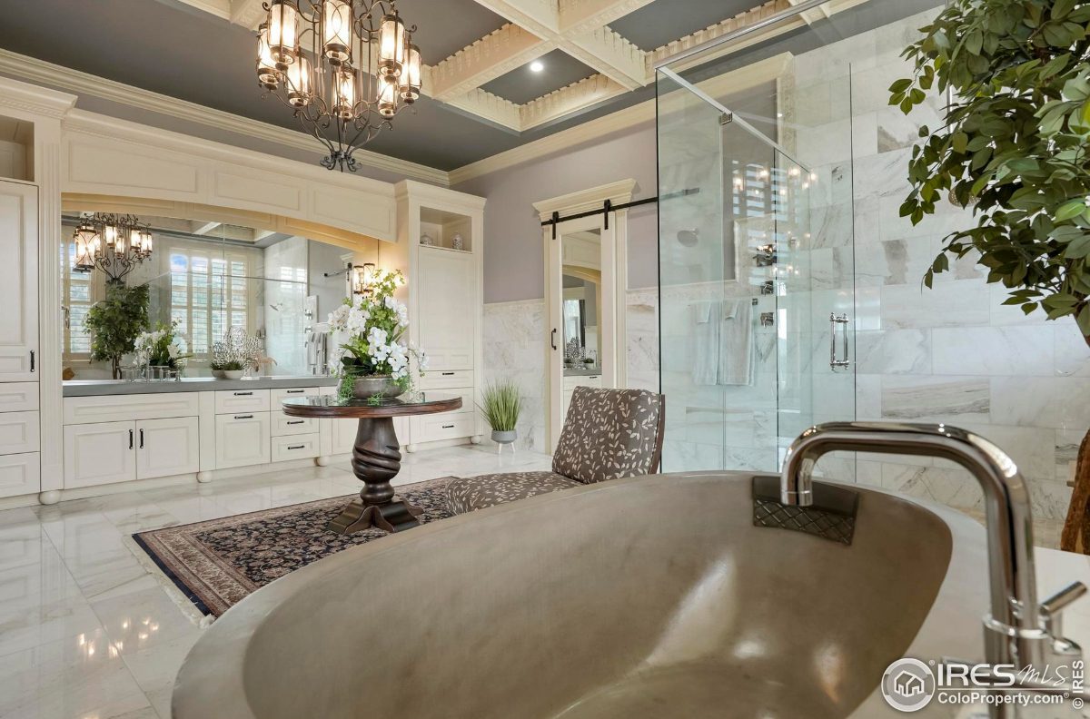 Spa-like bathroom boasts a large soaking tub, double vanities, and a walk-in shower.