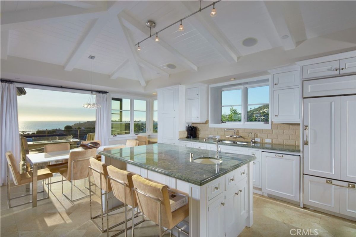 Ocean views are a highlight of this bright, white kitchen.