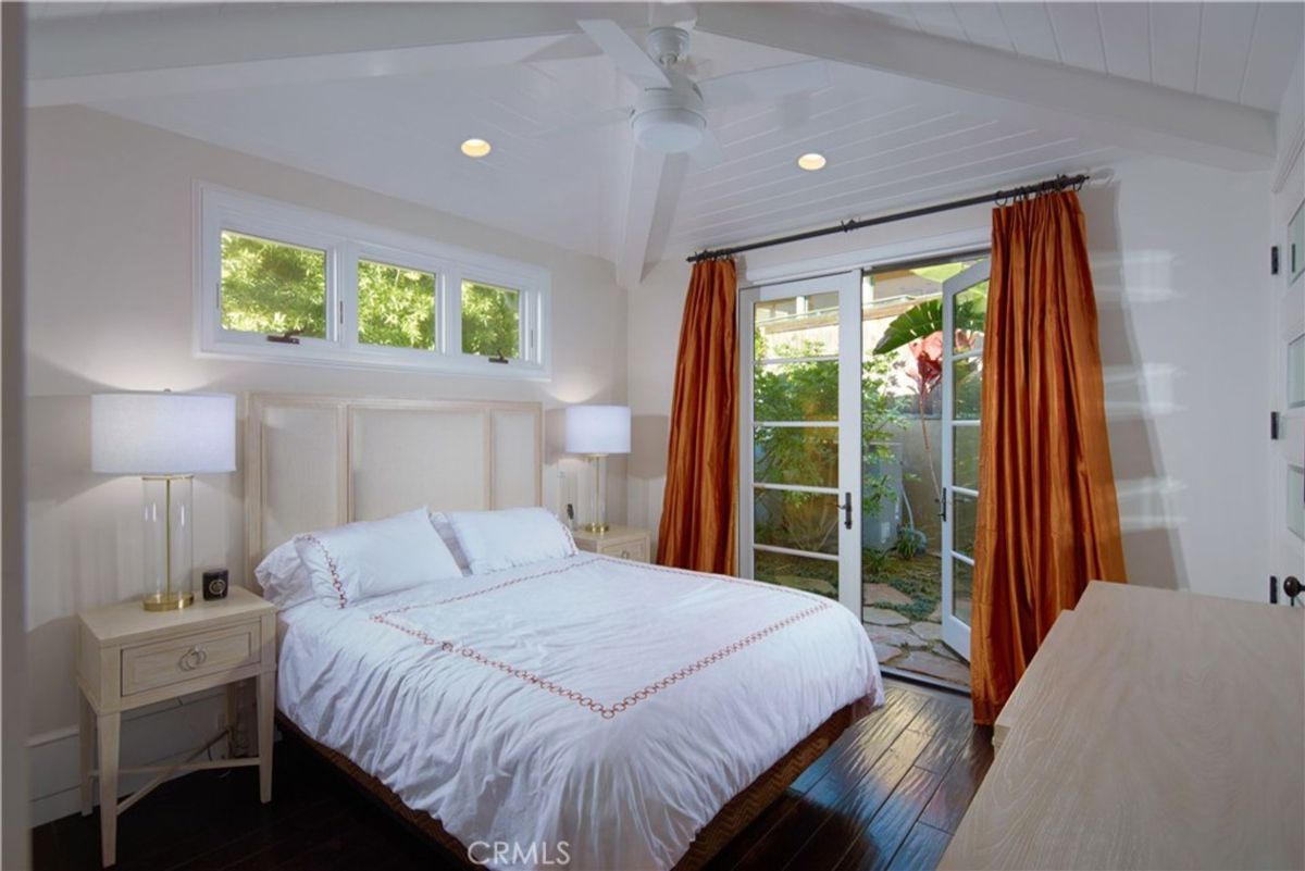 Bedroom with French doors that open to a private patio.