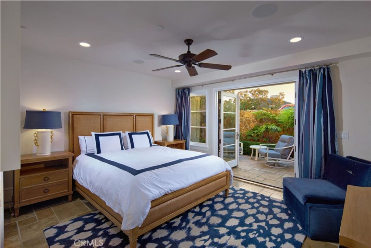 Bedroom with French doors that open to a patio.