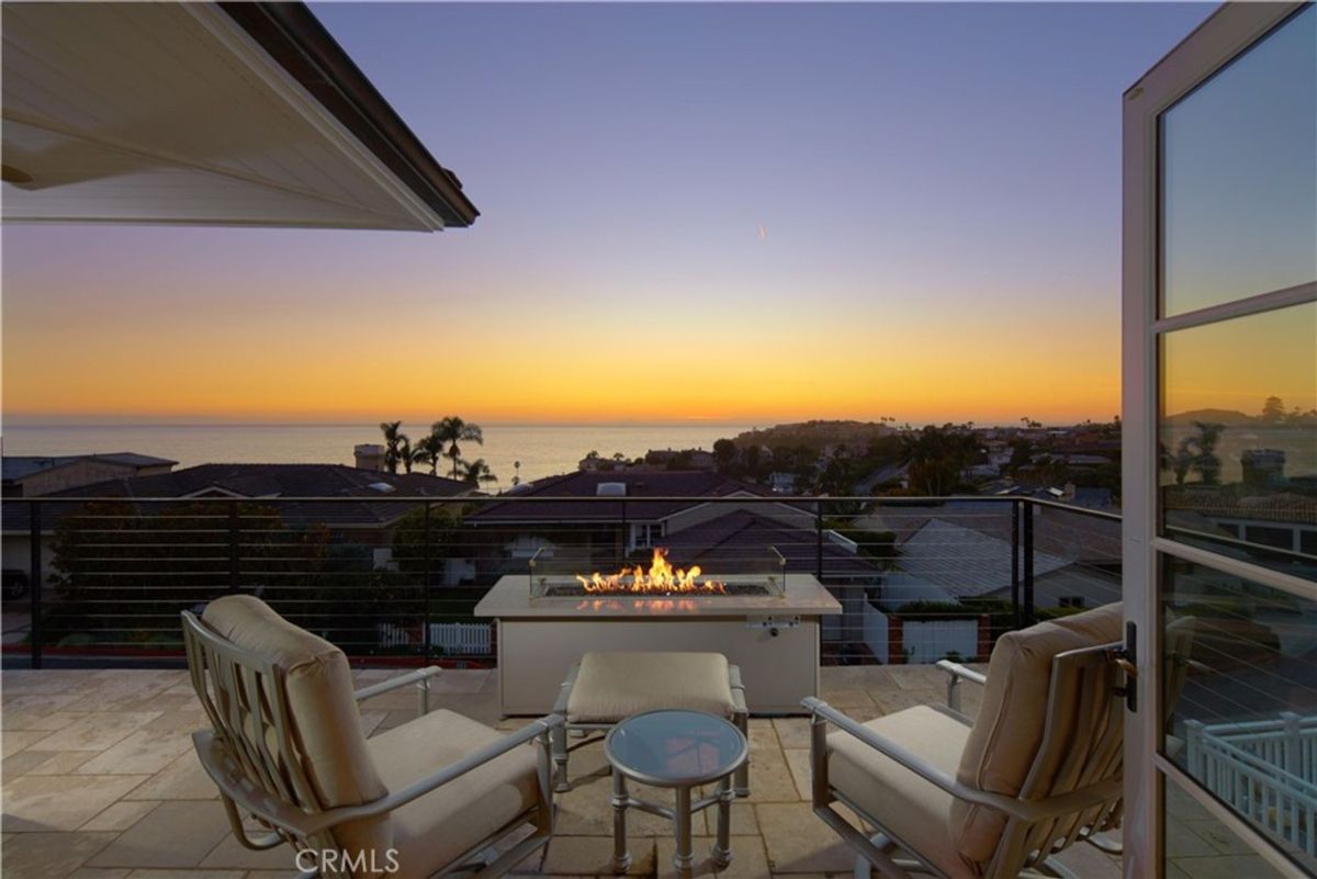 An ocean view from a deck with a fire pit.