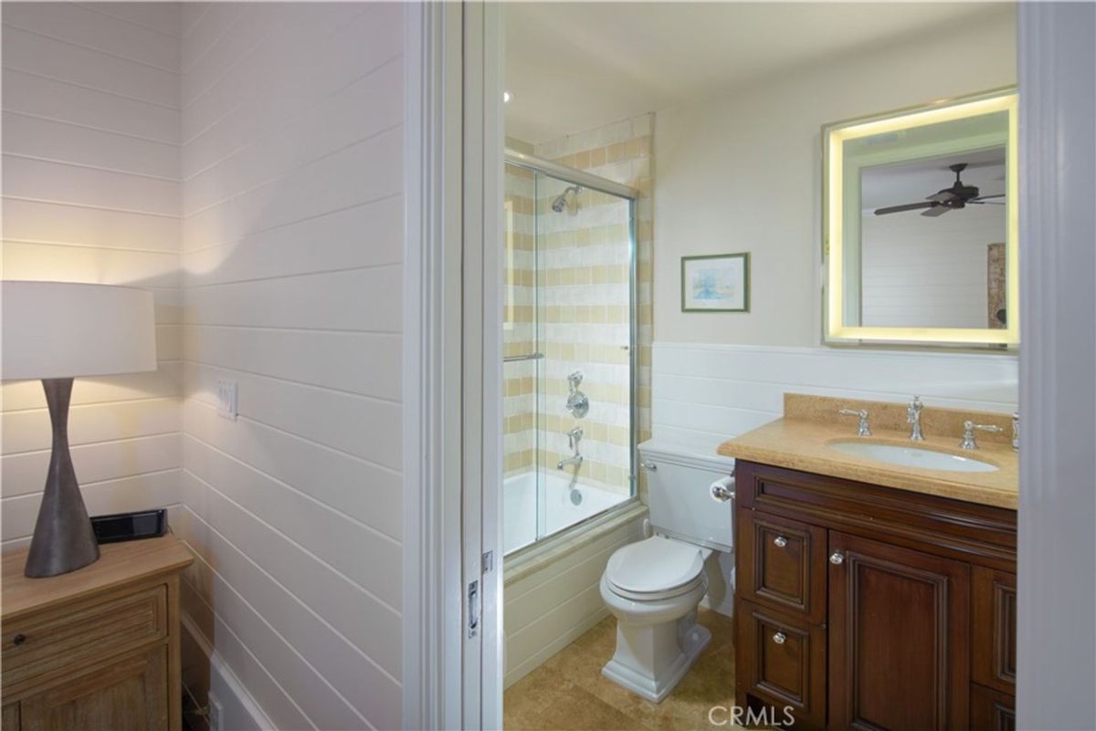 A bathroom with a shower, vanity and a bathtub.