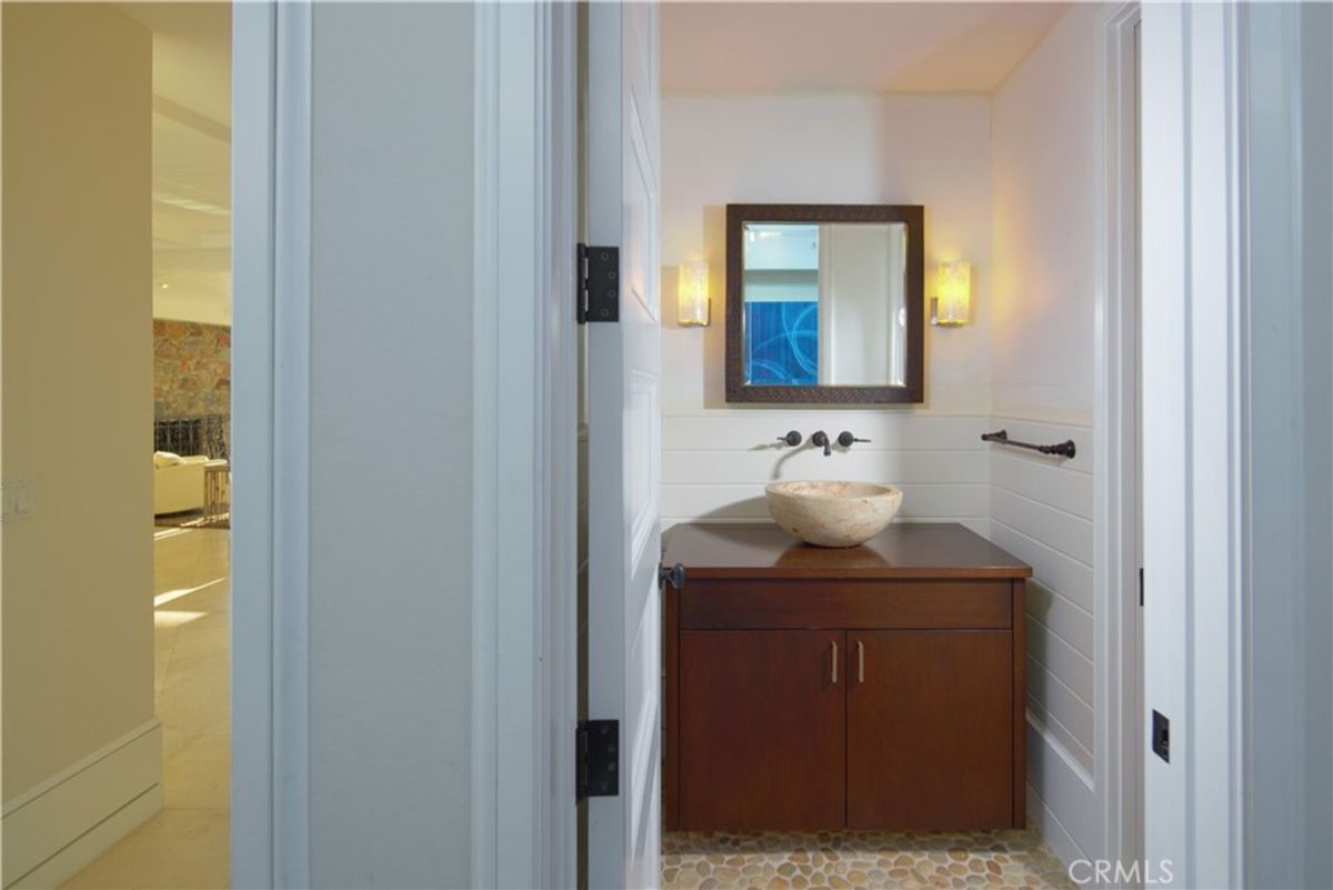 A powder room with a vessel sink.