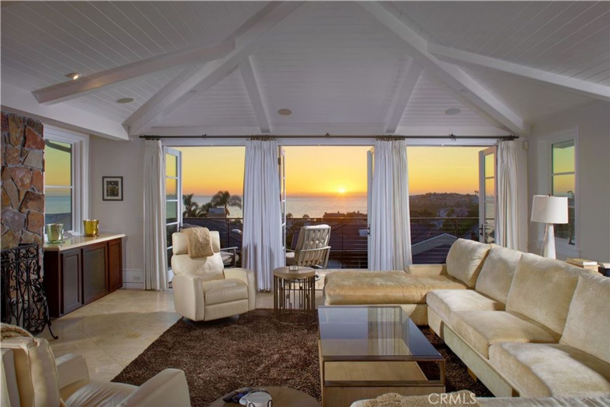 Ocean views enhance a living room's sunset ambiance.