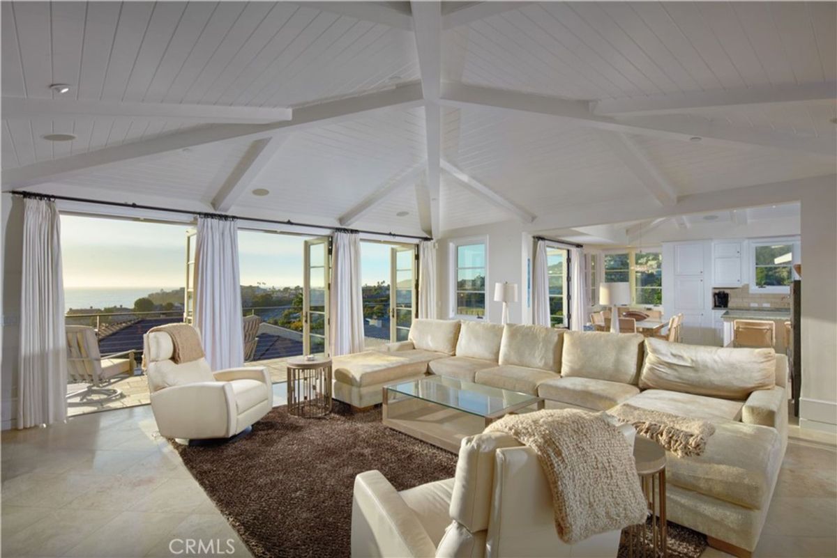 Expansive windows showcase panoramic ocean views from a spacious living area.