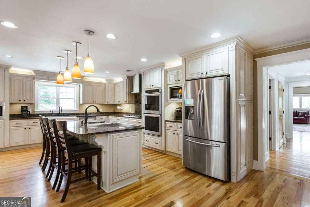 Kitchen view emphasizes modern appliances, extended counter space, and an open layout.