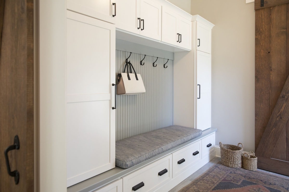 This custom-built entryway bench offers both style and practicality, providing ample storage and a convenient seating area. The clean lines and neutral color palette create a sophisticated and welcoming first impression.