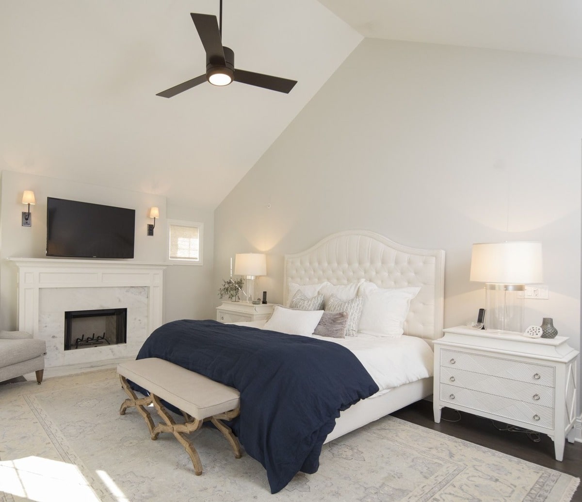 High ceilings and a spacious layout define this luxurious master suite, creating a sense of airy grandeur. The carefully chosen furnishings and decor enhance the room's sense of calm and spaciousness.