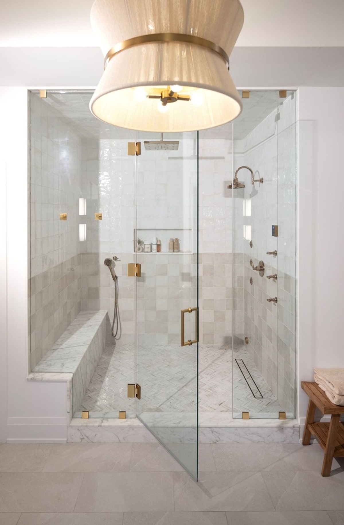 The shower's design creates a tranquil and spa-like atmosphere, perfect for relaxation and rejuvenation. The combination of neutral tones, clean lines, and high-end fixtures promotes a sense of calm and serenity.