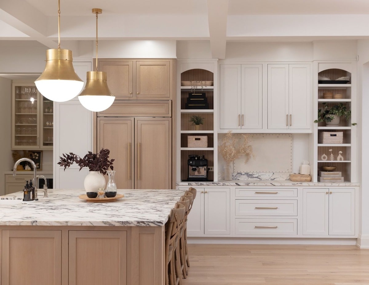 The kitchen's thoughtfully designed layout maximizes both functionality and storage, with ample counter space and integrated shelving. The combination of open shelving and closed cabinetry provides both visual appeal and practical organization.