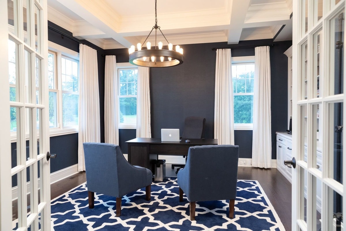 Designed for both style and productivity, this home office features ample natural light and a spacious layout perfect for focused work. The built-in cabinetry and comfortable seating create a functional and inviting workspace.