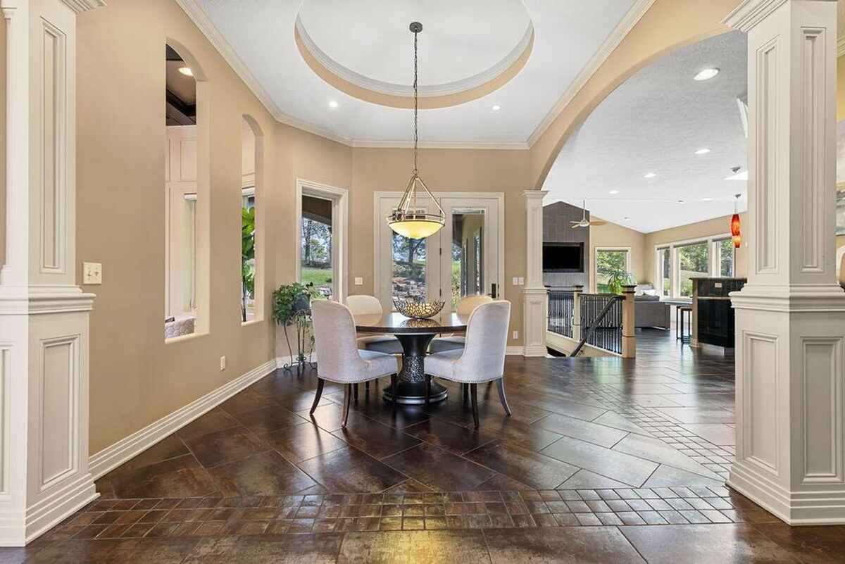 Dining nook with circular seating arrangement and a contemporary light fixture, seamlessly connecting to the living space.